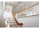 Elegant wood and white staircase with pendant lights and shiplap accent walls at 2618 Raven Dr, Sullivans Island, SC 29482