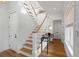 Elegant staircase featuring white wood risers, wood steps, and natural light at 2618 Raven Dr, Sullivans Island, SC 29482