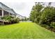 Manicured backyard featuring lush lawn and tropical landscaping at 2632 Alderly Ln, Mount Pleasant, SC 29466