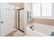 Bright bathroom featuring tub, walk-in shower, and white shutters on the window at 2632 Alderly Ln, Mount Pleasant, SC 29466