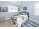Cozy bedroom with light blue walls, a ceiling fan, a decorative rug and a comfortable bed at 2632 Alderly Ln, Mount Pleasant, SC 29466