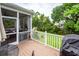 Outdoor deck with patio furniture and a grill next to a screened porch with lush landscaping at 2632 Alderly Ln, Mount Pleasant, SC 29466