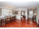 Bright dining room with hardwood floors, stylish lighting, and plantation shutters provides an elegant gathering space at 2632 Alderly Ln, Mount Pleasant, SC 29466