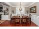 Elegant dining room with dark wood table, stylish chairs, chandelier, and wainscoting details at 2632 Alderly Ln, Mount Pleasant, SC 29466