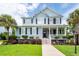 Charming two-story home with a welcoming front porch, manicured lawn, and mature trees at 2632 Alderly Ln, Mount Pleasant, SC 29466