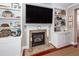 Elegant fireplace with detailed stonework and built-in shelving creates a cozy and stylish focal point in living room at 2632 Alderly Ln, Mount Pleasant, SC 29466