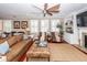 Inviting living room with a fireplace, built-in shelving, hardwood floors, and natural light from large windows at 2632 Alderly Ln, Mount Pleasant, SC 29466