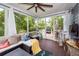 Cozy screened porch with outdoor views featuring comfortable seating, a ceiling fan and patio furniture at 2632 Alderly Ln, Mount Pleasant, SC 29466
