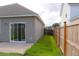 View of backyard with sliding glass doors and a wood fence at 303 Citation Way, Moncks Corner, SC 29461