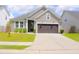 Charming single Gathering home with a two-car garage, well-manicured lawn and neutral color scheme at 303 Citation Way, Moncks Corner, SC 29461