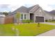 Charming single-Gathering home with a two-car garage, well-manicured lawn and neutral color scheme at 303 Citation Way, Moncks Corner, SC 29461