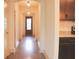 Bright hallway with gleaming hardwood floors leads to the front door and features adjacent kitchen area at 303 Citation Way, Moncks Corner, SC 29461