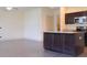 Bright and airy kitchen has a kitchen island, dark wood cabinets, and stainless steel appliances at 303 Citation Way, Moncks Corner, SC 29461