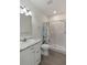 Bathroom features a shower-tub combination with a seashell-themed curtain and a bright vanity at 31 W 9Th St, Folly Beach, SC 29439