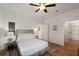 Bright bedroom featuring wood floors, a queen bed, and ensuite bath at 31 W 9Th St, Folly Beach, SC 29439