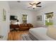 Cozy bedroom with leather sofa, TV, and natural light from the window at 31 W 9Th St, Folly Beach, SC 29439