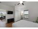 Bedroom featuring light-colored hardwood floors, a queen bed, and a large flat screen tv at 31 W 9Th St, Folly Beach, SC 29439