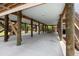 Carport space featuring wooden beams and wooden stairs leading to the upper level at 31 W 9Th St, Folly Beach, SC 29439