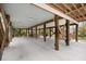 Spacious carport with concrete slab, wooden beams, seating and a grill at 31 W 9Th St, Folly Beach, SC 29439