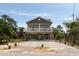 Well-maintained elevated beach house with a covered porch and outdoor parking at 31 W 9Th St, Folly Beach, SC 29439