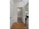 Hallway view into a bathroom and a bedroom featuring white doors and warm wood-look floors at 31 W 9Th St, Folly Beach, SC 29439