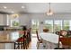 Well-lit kitchen boasts a breakfast bar and seamless transition into the dining and living areas at 31 W 9Th St, Folly Beach, SC 29439