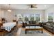Inviting living room features cozy seating, a ceiling fan, and natural light from the multiple windows at 31 W 9Th St, Folly Beach, SC 29439