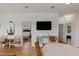 Open-concept living room with a mounted television, white walls, and views into the bedrooms at 31 W 9Th St, Folly Beach, SC 29439