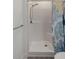 Walk-in shower featuring a showerhead, seat, shower curtain and hand rail at 31 W 9Th St, Folly Beach, SC 29439