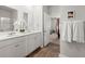 Bathroom features dual sinks, white cabinetry, and wood-look floors at 315 Black Birch Dr, Summerville, SC 29486