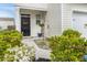Charming entryway with a decorative wreath, flowering plants, and walkway to front door at 315 Black Birch Dr, Summerville, SC 29486