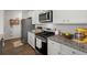 Bright kitchen features granite countertops, stainless steel appliances, and white cabinets at 315 Black Birch Dr, Summerville, SC 29486