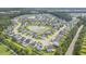 Aerial view of the neighborhood showcasing houses surrounding a pond and green trees at 341 Drayton Place Drive Dr, Moncks Corner, SC 29461