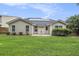 View of the back exterior of the home with a manicured lawn and rear patio at 341 Drayton Place Drive Dr, Moncks Corner, SC 29461