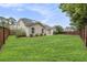 Large backyard featuring lush green grass, landscaping, and privacy fencing at 341 Drayton Place Drive Dr, Moncks Corner, SC 29461