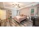 Comfortable bedroom featuring tray ceilings, modern flooring, and great natural lighting at 341 Drayton Place Drive Dr, Moncks Corner, SC 29461