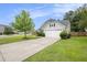 Home featuring a two-car garage and a well-manicured lawn at 341 Drayton Place Drive Dr, Moncks Corner, SC 29461