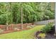 Landscaped backyard features mature trees, green grass, and a wood fence at 3486 Ashwycke St, Mount Pleasant, SC 29466
