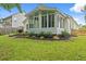 Well-maintained backyard features lush green grass, mulch beds, and a screened-in porch at 3486 Ashwycke St, Mount Pleasant, SC 29466