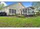 Well-maintained backyard features lush green grass, mulch beds, and a screened-in porch at 3486 Ashwycke St, Mount Pleasant, SC 29466