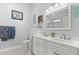 Bright bathroom featuring double vanity, neutral color palette, and decorative mirror with nautical decor at 3486 Ashwycke St, Mount Pleasant, SC 29466