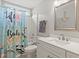 Coastal-themed bathroom with a blue shower curtain, and white vanity, creating a serene and inviting space at 3486 Ashwycke St, Mount Pleasant, SC 29466