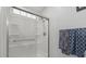 A modern bathroom with sleek shower featuring a frameless glass enclosure, and patterned decorative towels at 3486 Ashwycke St, Mount Pleasant, SC 29466