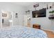 This is a charming bedroom with a TV, wood floors, a walk-in closet and a full ensuite bathroom at 3486 Ashwycke St, Mount Pleasant, SC 29466