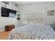 A cozy bedroom with a TV, an accent wall decor, a wood trunk and plenty of natural light at 3486 Ashwycke St, Mount Pleasant, SC 29466