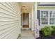 Welcoming front porch with decorative welcome sign, plants, and front door at 3486 Ashwycke St, Mount Pleasant, SC 29466