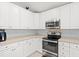 Well-lit kitchen with white cabinets, stainless steel appliances, and ample counter space at 3486 Ashwycke St, Mount Pleasant, SC 29466