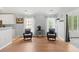 Comfortable living room with hardwood floors, two chairs, and lots of natural light from large windows at 3486 Ashwycke St, Mount Pleasant, SC 29466