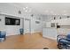 Open concept living room and kitchen with hardwood floors and a large screen TV at 3486 Ashwycke St, Mount Pleasant, SC 29466