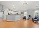 Open concept living room with hardwood floors and kitchen with stainless steel appliances and breakfast bar at 3486 Ashwycke St, Mount Pleasant, SC 29466